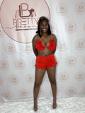 A red bra and shorts set with a lace-up design and ruffle details—perfect for a fun, flirty vibe.

