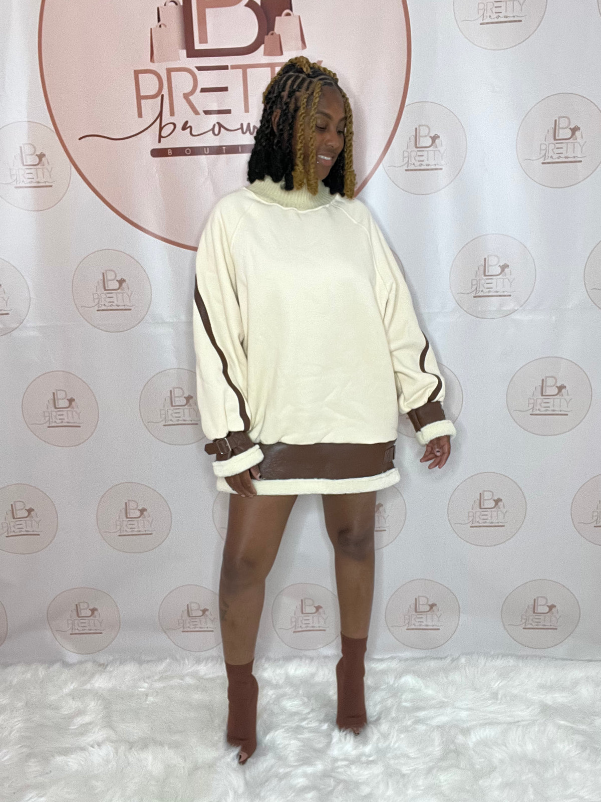 Keep it cute and effortless in the Karlie Babe Dress! This oversized sweater dress is the perfect mix of cozy and edgy with faux leather &amp; buckle details.

-Round neckline
-Long sleeves
-Faux leather &amp; buckle detail
-65% Polyester, 35% Cotton
-One size