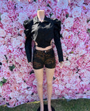 The Lori Top is serving chic with a little edge! This black crop top features a zip-up collar, mini puff shoulders, and a bustier-style front for the perfect mix of structure and style.

-Cropped fit
-Collar neckline
-Mini puff shoulder detail
-Long sleeves
-Bustier-style front