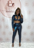 The Glistening Bae Pant Set is a bold look that screams confidence. Featuring a crop top with a collar, long sleeves, and a cute cutout design, paired with high-waisted pants for the perfect fit.