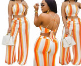 Turn heads in this orange and white set, featuring a crop top and long pants—perfect for beach vibes or casual days out.