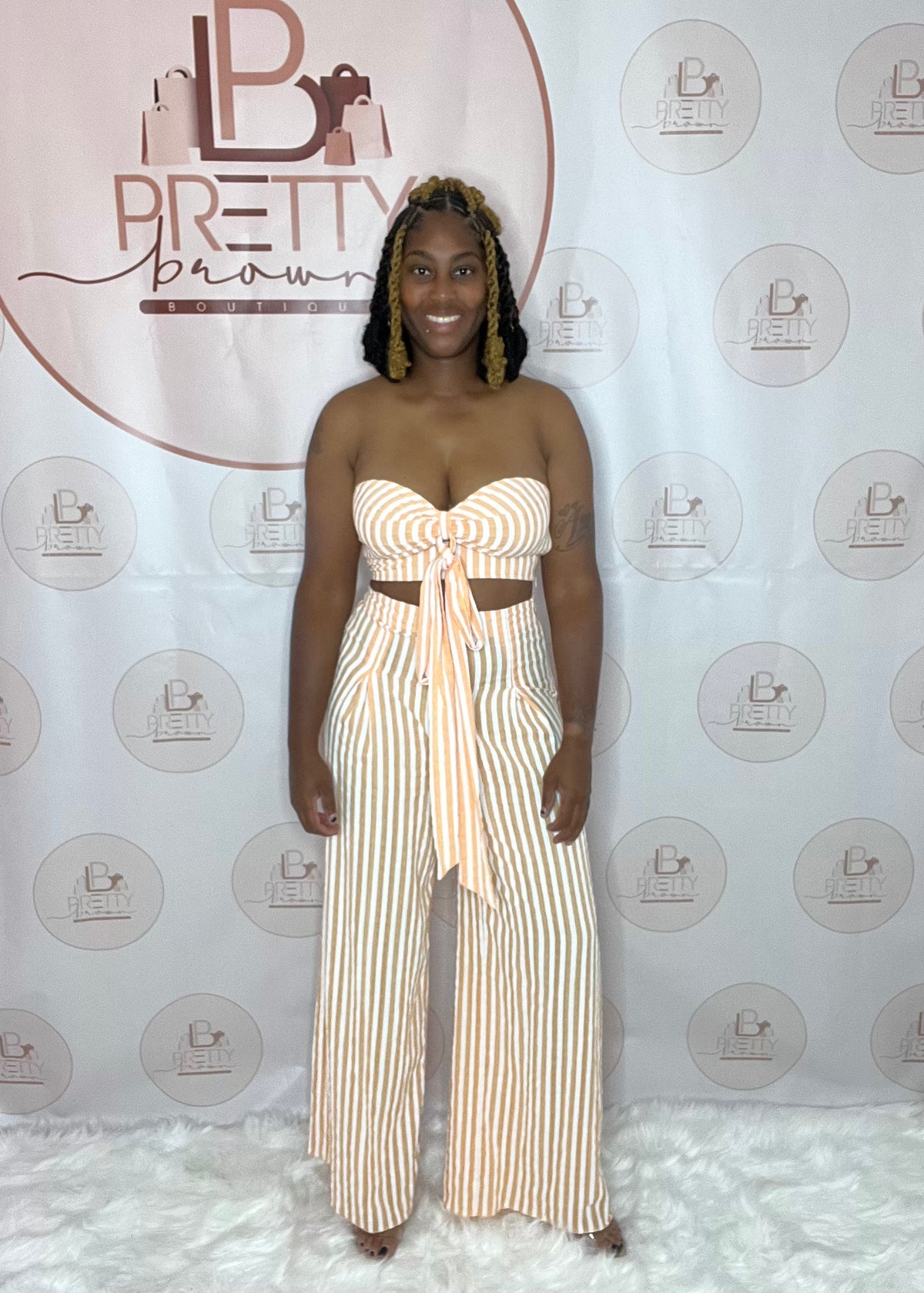 The Peach Set for the Brown Girlies is giving all the right vibes! This two-piece set features a tube top with a keyhole cutout, self-tie detail, and high-waisted pants with wide legs.

-High-waisted pants with wide legs
-Self-tie and side zipper closure
-Non-stretch fabric, 70% cotton,&nbsp;30% rayon