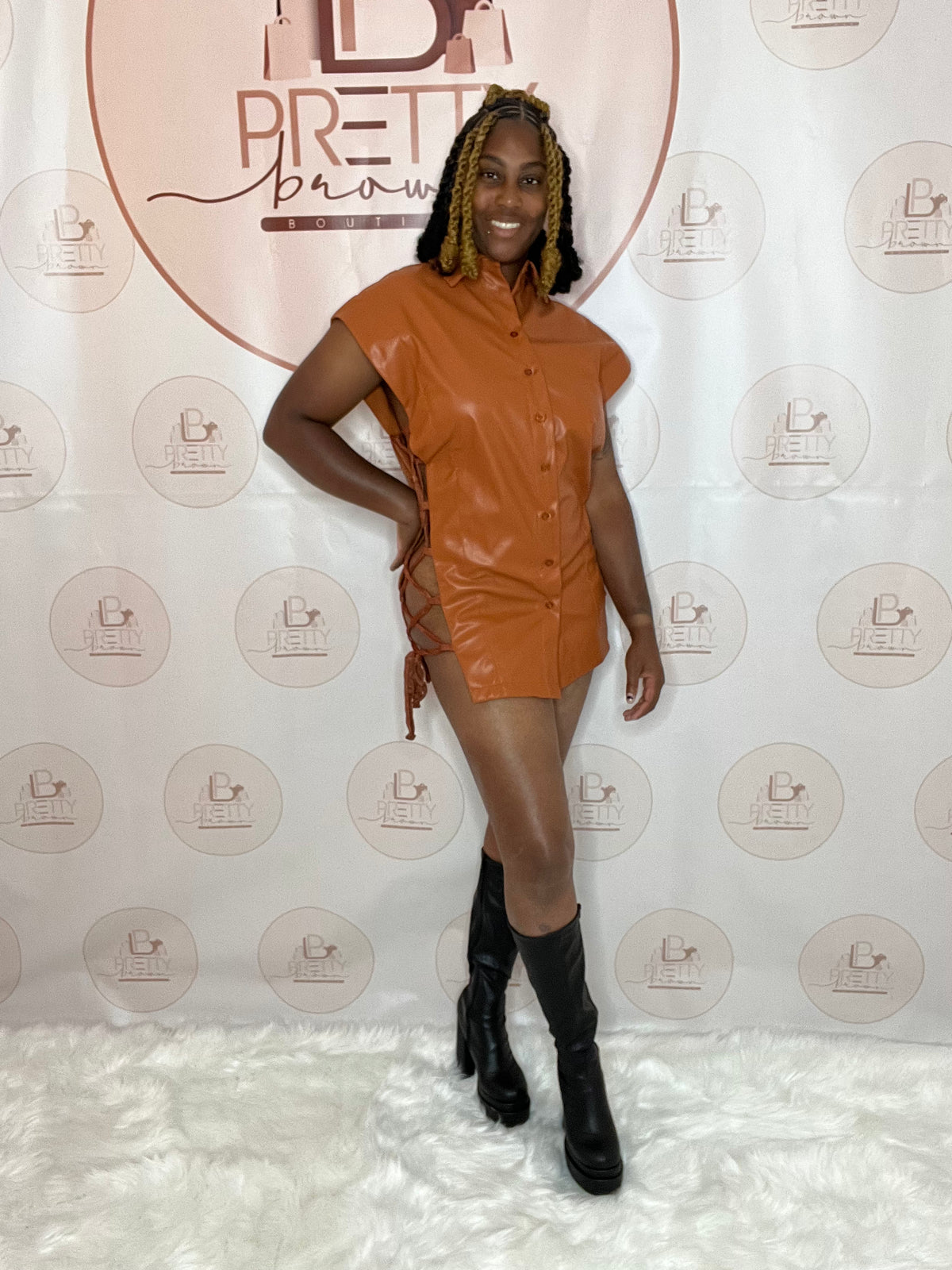 The MCM Leather inspired dress is giving bold and sexy! This faux leather dress brings all the details with side cutouts, lace-up sides, and a self-tie closure for the perfect fit.

-Collar neckline
-Sleeveless
-Side cutouts &amp; lace-up detail
-Self-tie &amp; button closure
-50% PU, 50% Polyester

Wash Cold*