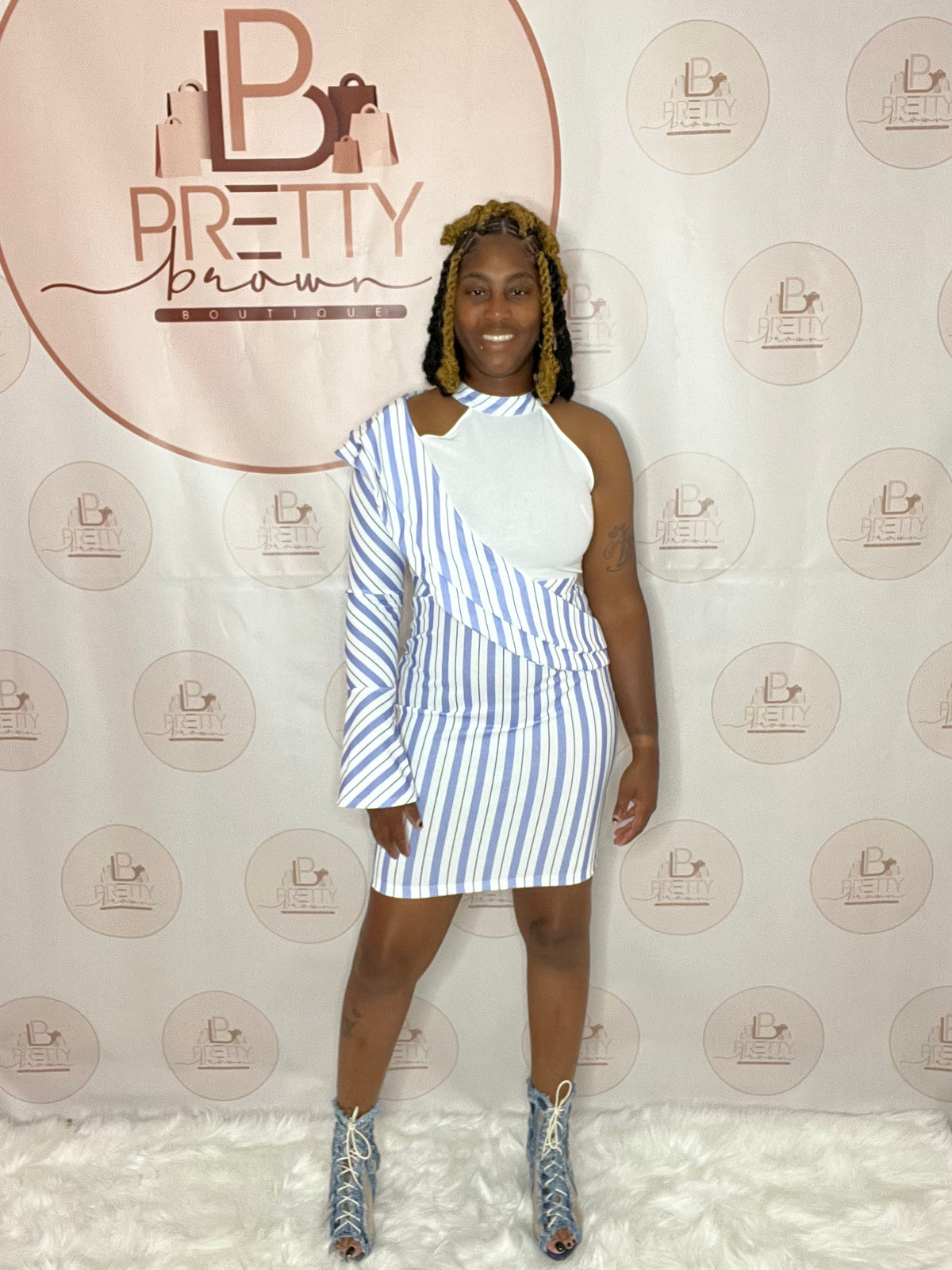 A pinstripe white and blue dress with a casual yet sexy, classy look—perfect for the office or after-work vibes